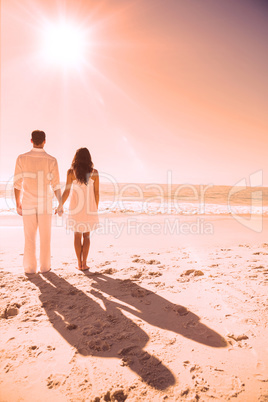 Attractive couple holding hands and watching the sea