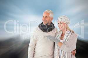 Composite image of happy couple in winter fashion looking