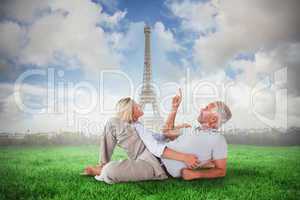 Composite image of smiling couple lying and looking up