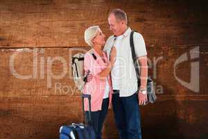 Composite image of smiling older couple going on their holidays
