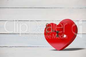 Bright red heart shaped lock with key