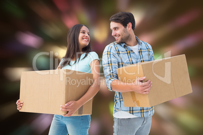 Composite image of happy young couple with moving boxes