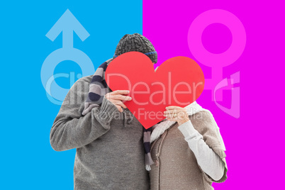 Composite image of happy mature couple in winter clothes holding