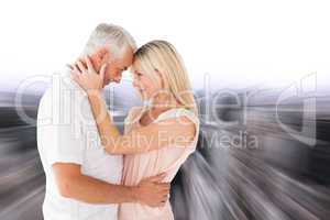 Composite image of affectionate couple standing and hugging