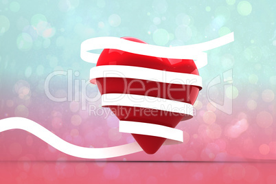 Composite image of love heart wrapped in ribbon