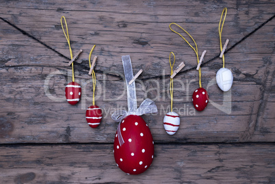 Many Red And White Easter Eggs And One Big Egg Hanging On Line