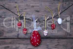 Many Red And White Easter Eggs And One Big Egg Hanging On Line