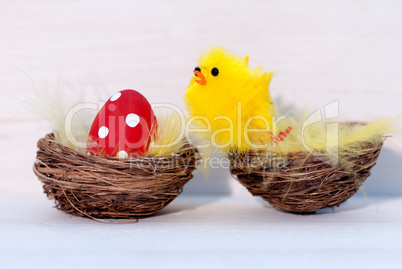 One Red Easter Egg And Yellow Chick In Nest