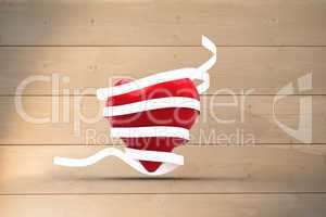 Composite image of love heart wrapped in ribbon