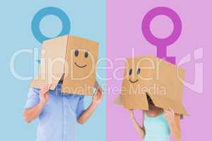 Composite image of couple wearing emoticon face boxes on their h