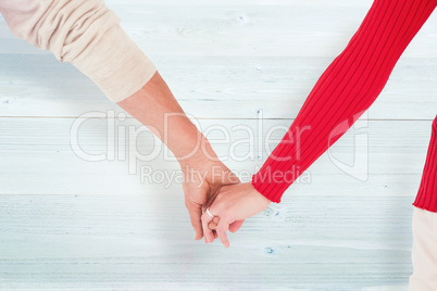 Composite image of couple holding hands rear view