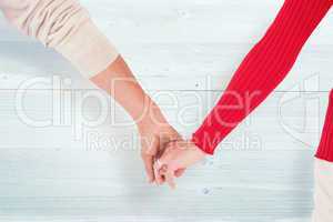 Composite image of couple holding hands rear view