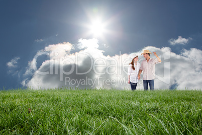 Composite image of smiling couple both wearing hats