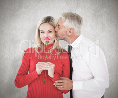 Composite image of handsome man giving his wife a kiss on cheek