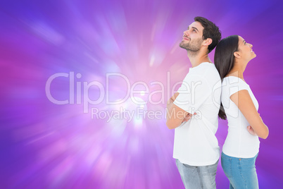 Composite image of happy couple standing looking up