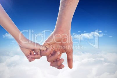 Composite image of loving young couple holding hands