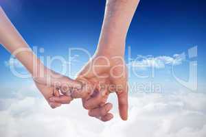 Composite image of loving young couple holding hands