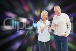 Composite image of happy mature couple using their smartphones