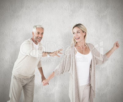 Composite image of happy couple messing about together