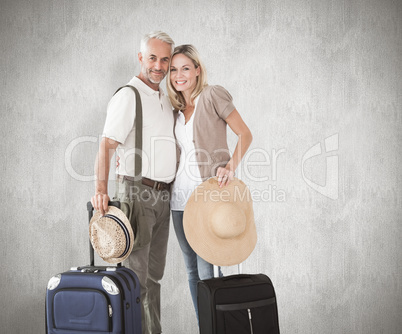 Composite image of happy couple ready to go on holiday