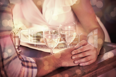 Couple holding hands at dinner