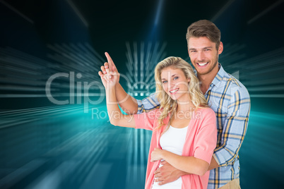 Composite image of attractive young couple embracing and pointin