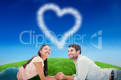 Composite image of attractive young couple looking up