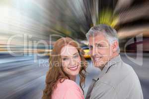 Composite image of casual couple smiling at camera