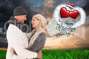 Composite image of happy couple in winter fashion embracing