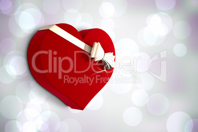 Composite image of heart shaped box of candy