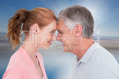 Composite image of casual couple smiling at each other