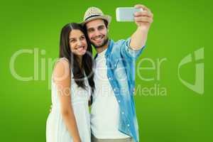 Composite image of happy hipster couple taking a selfie