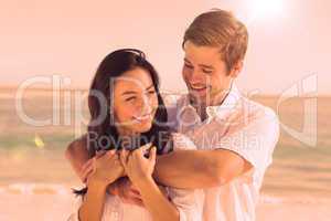 Cheerful couple relaxing on the beach during summer