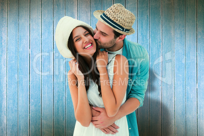 Composite image of happy hipster couple hugging and smiling