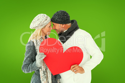 Composite image of smiling couple in winter fashion posing with