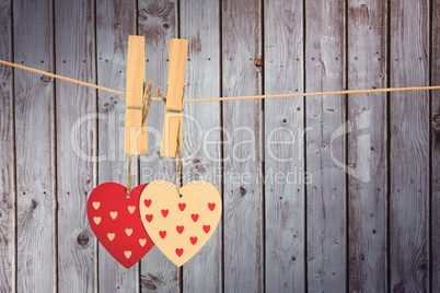 Composite image of hearts hanging on the line