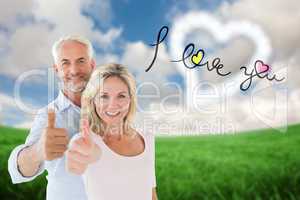 Composite image of smiling couple showing thumbs up together