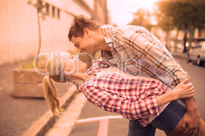 Hip romantic couple dancing in the street