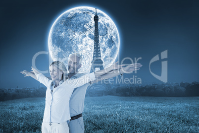 Composite image of happy couple standing with arms outstretched