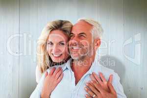 Composite image of smiling couple embracing with woman looking a