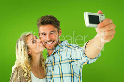 Composite image of attractive couple taking a selfie together