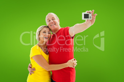 Composite image of happy mature couple taking a selfie together