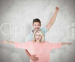 Composite image of attractive couple smiling and cheering