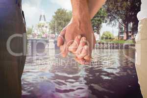 Composite image of happy senior couple holding hands