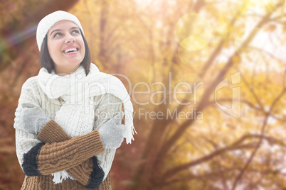 Composite image of brunette in warm clothing