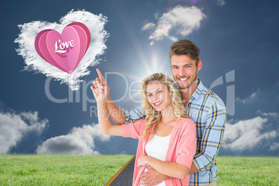 Composite image of attractive young couple embracing and pointin