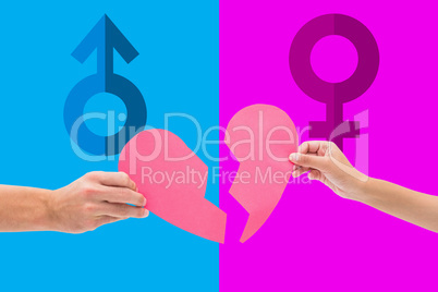 Composite image of hands holding two halves of broken heart