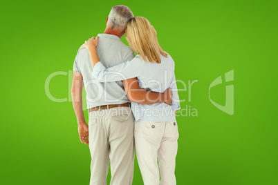 Composite image of happy couple standing and looking