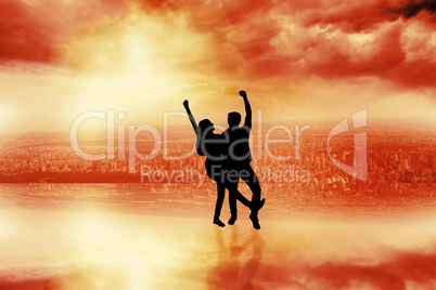 Composite image of happy casual couple cheering together Composite image of happy casual couple cheering together