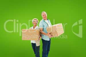 Composite image of older couple smiling at camera holding moving